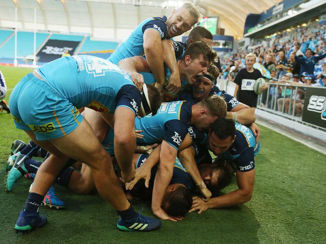 Alexander Brimson of the Titans celebrates a try with team mates during the round 11 NRL match between the Gold Coast Titans and the Newcastle Knights at Cbus Super Stadium in May. (Photo by Chris Hyde/Getty Images)