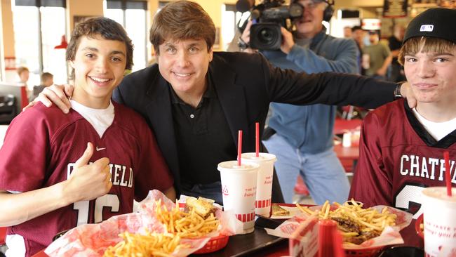 Blagojevich posed with two high school students at a fast food restaurant just minutes before turning himself into prison, in 2012. Picture: AP