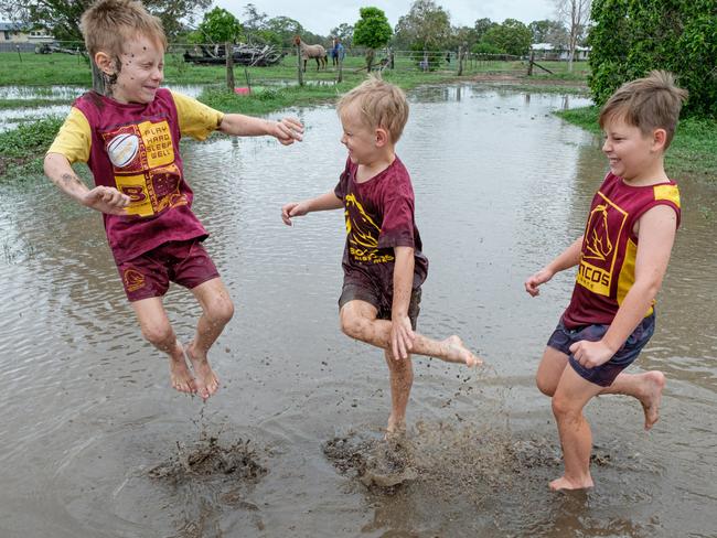 Ryan (6), Max (7) and Hayden (8) Clark playing in puddles left after rain came through at their North Bundaberg paddock. Photo - Paul Beutel