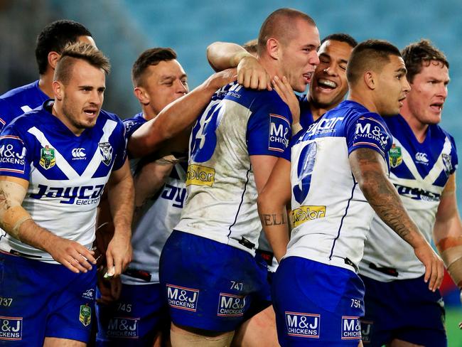 David Klemmer celebrates a try with his teammates.