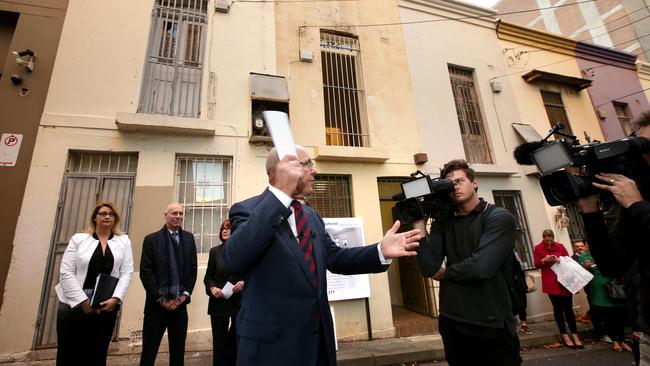 Sydney's narrowest house auction at 29 Terry St Surry Hills. The property sold for $965,000 to a Chinese phone bidder, ( tall asian man with Samsung phone & card 28, closest other bidder was man and woman card 8) Pic Stephen Cooper