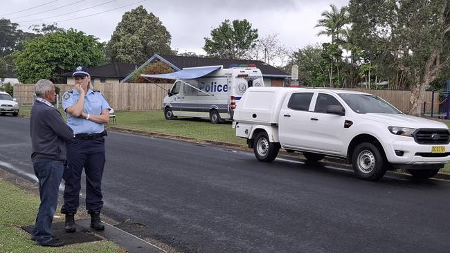 A man speaks to a NSW Police officer on Kurrajong St on Thursday afternoon. Picture: Toni Moon/NewsLocal