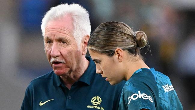 GOLD COAST, AUSTRALIA - DECEMBER 01: Tom Sermanni, Interim Head Coach of Australia speaks to Tameka Yallop, Emily van Egmond and Kyra Cooney-Cross of Australia during warm up prior to  the International Friendly match between the Matildas and Brazil at Cbus Super Stadium on December 01, 2024 in Gold Coast, Australia. (Photo by Bradley Kanaris/Getty Images)