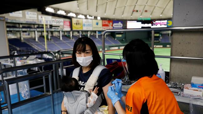 A woman receives a Covid-19 vaccine at the Tokyo Dome this week. About two in five Japanese have been inoculated. Picture: Reuters