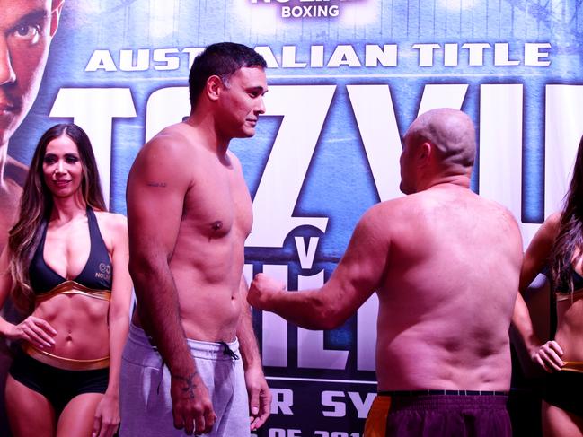 Justin Hodges looks down at his much smaller opponent Troy McMahon at the weigh-in for their fight at The Star in Sydney. Picture: Jonathan Ng