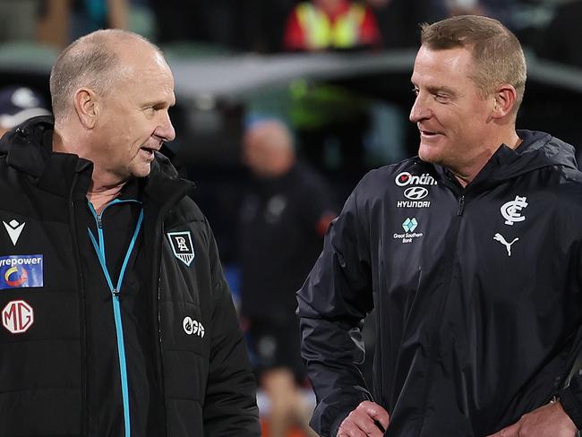 ADELAIDE, AUSTRALIA - MAY 30: Ken Hinkley, Senior Coach of the Power talks to Michael Voss, Senior Coach of the Blues during the 2024 AFL Round 12 match between the Port Adelaide Power and the Carlton Blues at Adelaide Oval on May 30, 2024 in Adelaide, Australia. (Photo by James Elsby/AFL Photos via Getty Images)