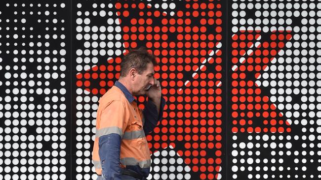 A man walks past a branch of the National Australia Bank in Sydney. (AFP PHOTO/Peter Parks)