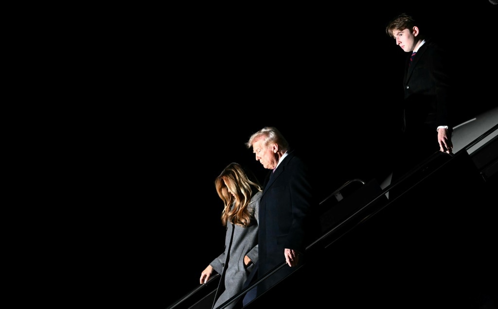 US President-elect Donald Trump, his wife Melania and son Barron arrive at Dulles International Airport in Virginia on January 18, 2025