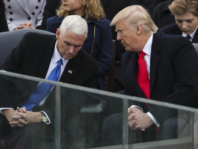 President Donald Trump leans over to talk with Vice President Mike Pence during the 58th Presidential Inauguration at the U.S. Capitol in Washington on January 20, 2017. Picture: AP