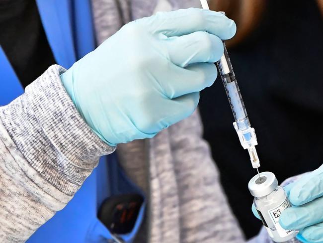 The Moderna Covid-19 vaccine is loaded into a syringe ahead of use on eligible people identified by homeless service agencies from the parking lot of the L.A. Mission on February 24, 2021 in Los Angeles, California. (Photo by Frederic J. BROWN / AFP)