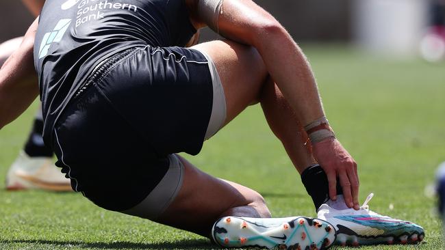 Patrick Cripps grabs at his right ankle after falling awkwardly. Picture: Michael Klein