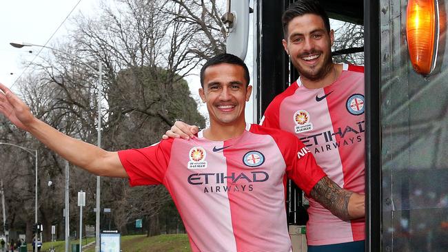 Tim Cahill (left) and teammate Bruno Fornaroli get used to Melbourne trams. Picture: Mark Stewart