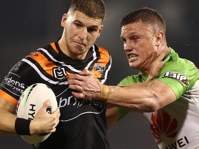 Adam Doueihi of the Tigers is tackled by Jack Wighton of the Raiders during the Round 5 NRL match between the Wests Tigers and the Canberra Raiders at Campbelltown Stadium in Sydney, Saturday, June 13, 2020. (AAP Image/Brendon Thorne) NO ARCHIVING, EDITORIAL USE ONLY