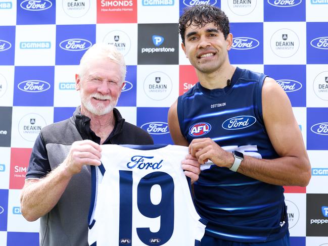 Former Geelong player Neville Bruns presents Jack Martin with the No.19. Picture: Geelong Cats