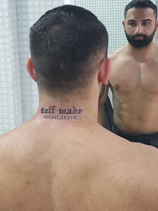 Sayet Erhan Akca posing after getting a tattoo.