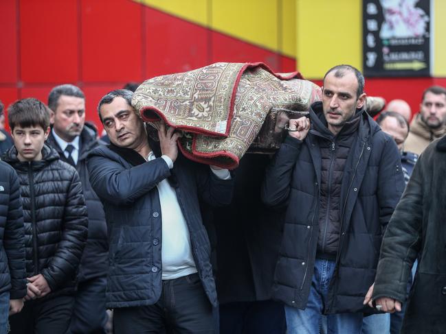 BAKU, AZERBAIJAN - DECEMBER 28: People carry the body of Mahammadali Eganov, 13 who died in the Azerbaijan Airlines Embraer 190 crash near Kazakhstan's Aktau airport, at his funeral on December 28, 2024 in Baku, Azerbaijan. (Photo by Aziz Karimov/Getty Images)