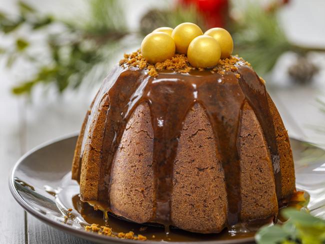 A Christmas pudding served with caramel sauce.