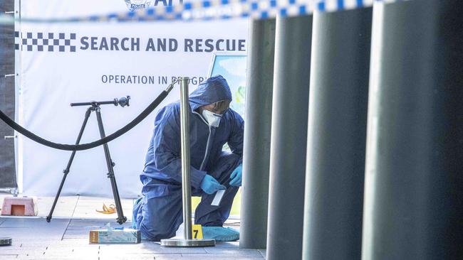 An AFP Forensic Officer outside the pub at the crime scene. Picture: Gary Ramage