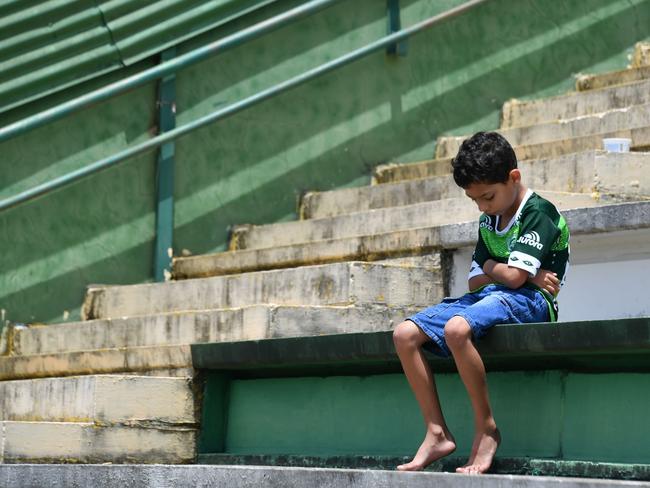 A boy sits alone on the stands during a tribute to the players of Brazilian team Chapecoense Real who were killed in a plane accident in the Colombian mountains, at the club’s Arena Conda stadium in Chapeco, in the southern Brazilian state of Santa Catarina, on November 29, 2016. Picture: AFP PHOTO / Nelson ALMEIDA