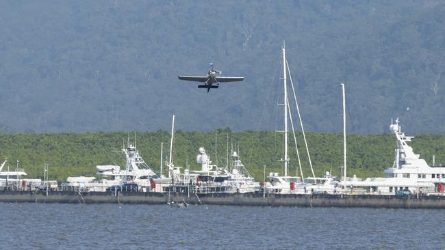 Red Bull air racer pilot Matt Hall flies his single seat stunt plane at low altitude over the Cairns Marlin Marina. Picture: Brendan Radke