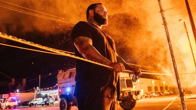 A man looks over police tape in Kenosha, Wisconsin during a second night of rioting last August following the shooting of Jacob Blake. Picture: AFP