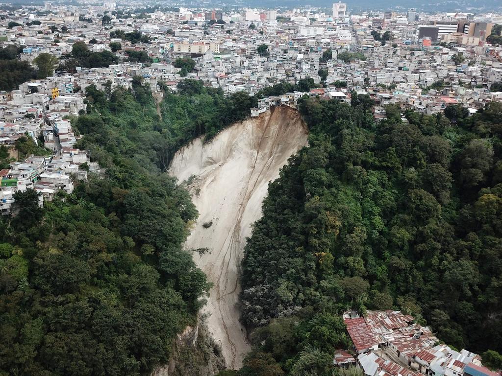 Houses teeter on the edge of a landslide in Guatemala City. Picture: Bomberos Voluntarios/AFP