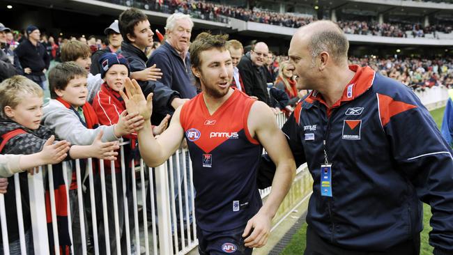 Brock McLean enjoys a Melbourne win with coach Dean Bailey and Demons fans.