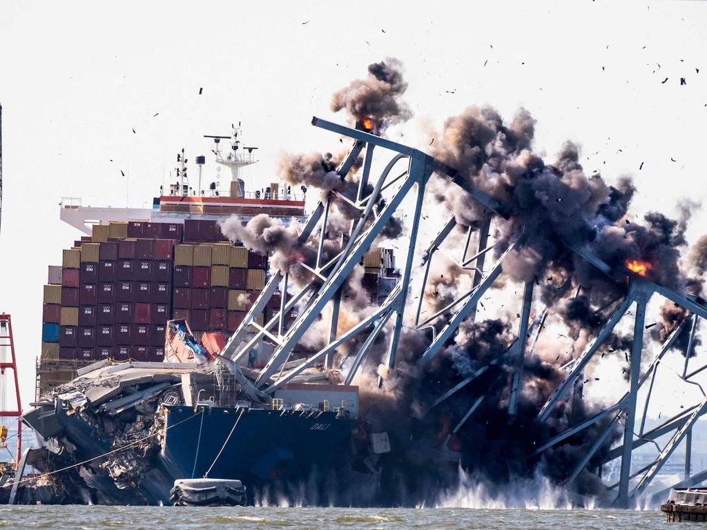 TOPSHOT - -- AFP PICTURES OF THE YEAR 2024 -- Crews conduct a controlled demolition of a section of the Francis Scott Key Bridge resting on the Dali container ship in Baltimore on May 13, 2024.. The Francis Scott Key Bridge, a major transit route into the busy port of Baltimore, collapsed on March 26 when the Dali container ship lost power and collided into a support column, killing six roadway construction workers. (Photo by ROBERTO SCHMIDT / AFP) / AFP PICTURES OF THE YEAR 2024