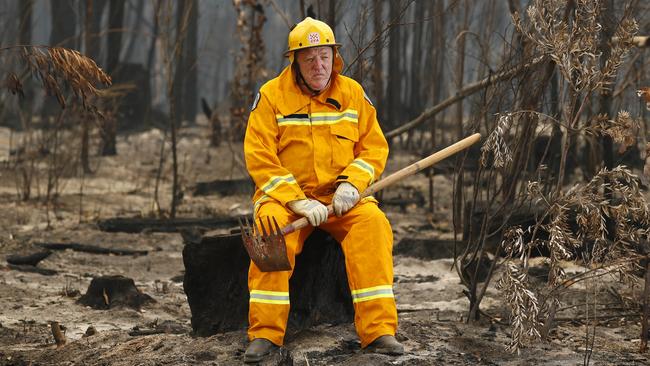 Lindsay McHugh takes a break from checking smouldering trees. Picture: David Caird