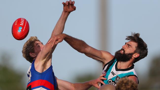 From opponents to teammates – Jack Hudson and Grady Hudd swooped on both Tim English <br/>(left) and Justin Westhoff. Picture: Matt Turner/AFL Photos via Getty Images.