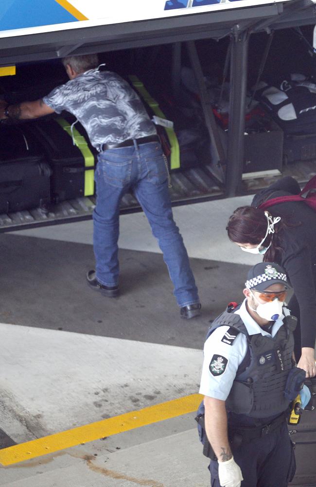 Police and Army personnel watch as Passengers arriving into Brisbane International Airport and forced into quarantine. Passengers getting off and being taken to buses before taken to hotels to quarantine, Sunday 29th March 2020 – Photo Steve Pohlner