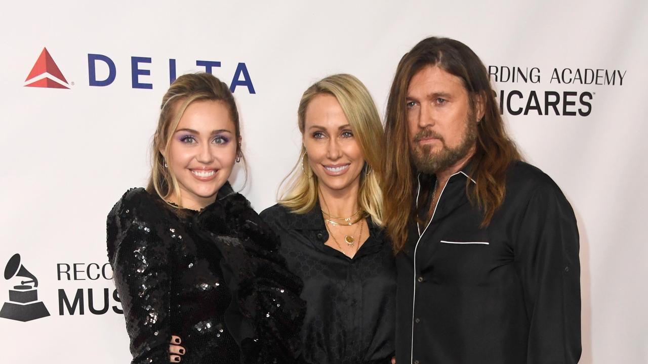 Happier times: Miley with both her parents in early 2019. Picture: Frazer Harrison/Getty