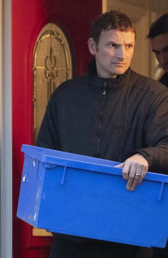 Police leave the home of suspects Joanna and Thomas Maher with an evidence box at Wiltshire Close in Warrington, Cheshire. Picture: AP