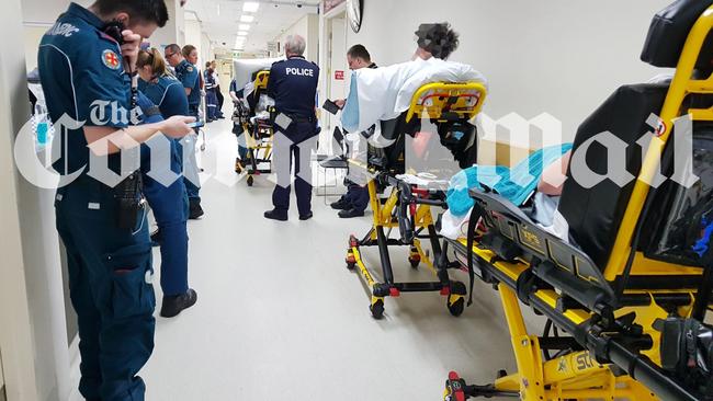 The whistleblower picture shows patients and emergency personnel waiting in a hallway at Princess Alexandra Hospital last September. Nurses say the practice is still happening.