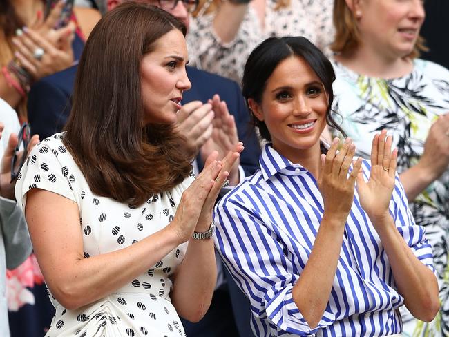 A rare relaxed moment between Kate and Meghan at Wimbledon in July. Picture: Getty Images