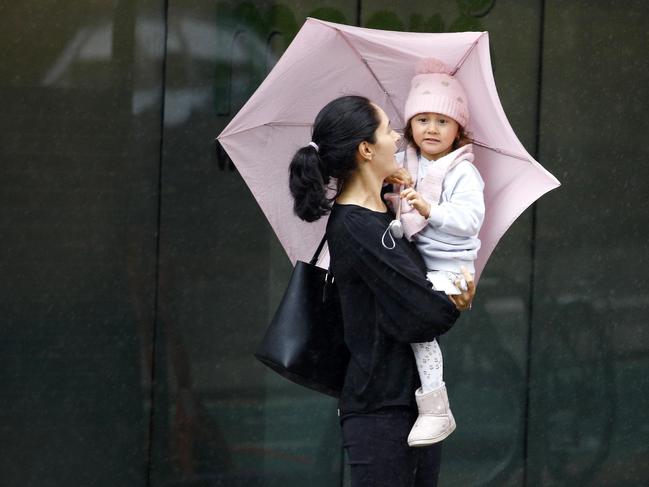BRISBANE, AUSTRALIA - NewsWire Photos DECMBER 1, 2022: Persistent rain and temperatures as low as 15 degrees had people in Brisbane bring out the brollies with the first day of summer resembling more of a winter feel. Picture: NCA NewsWire/Tertius Pickard
