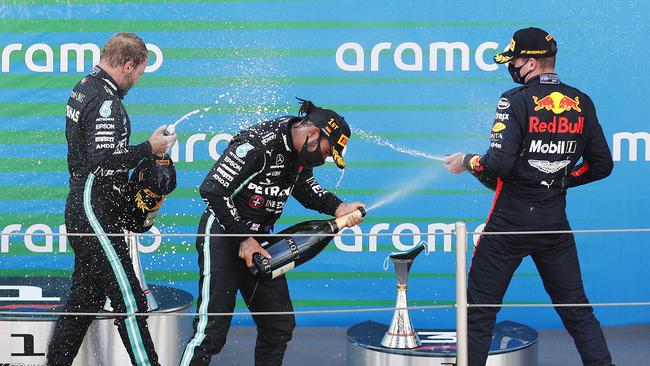 Lewis Hamilton on the podium with Max Verstappen and Valtteri Bottas