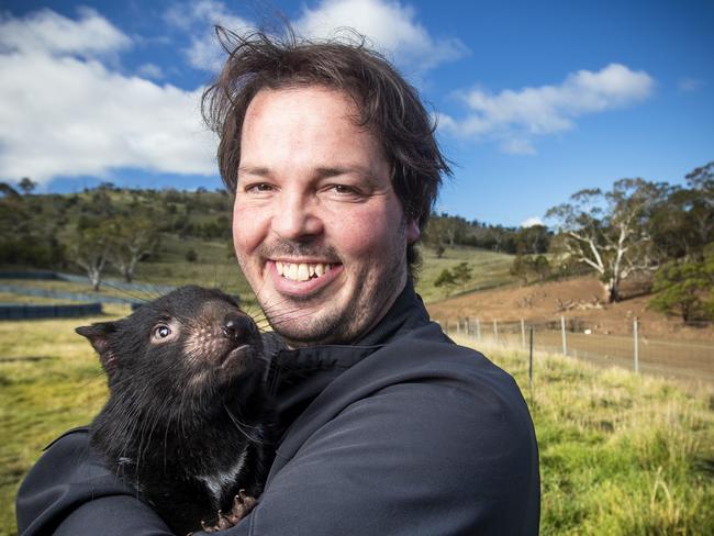 Bonorong Wildlife Sanctuary's Greg Irons with a junior Tasmanian devil. Picture: LUKE BOWDEN