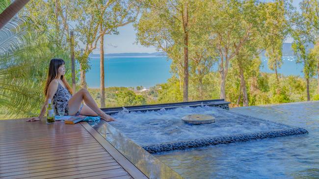 A luxurious spa and pool, complete with swim-up bar, are some of the features of this Airlie Beach home.