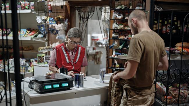 A soldier buys some cans of Red Bull in a store near the Russian border in the Sumy region of Ukraine. Picture: Kostiantyn Liberov/Libkos/Getty Images