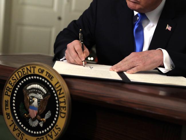 Donald Trump signs a proclamation to recognie Jerusalem as the capital of Israel. Picture: AP/Evan Vucci