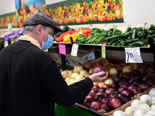 A customer browses produce at a stall inside Grand Central Market on March 11, 2022 in downtown Los Angeles, California. - US consumer prices hit a new 40-year high in February 2022 as the world's largest economy continued to be battered by a surge of inflation, which the fallout from Russia's invasion of Ukraine is expected to worsen. (Photo by Patrick T. FALLON / AFP)