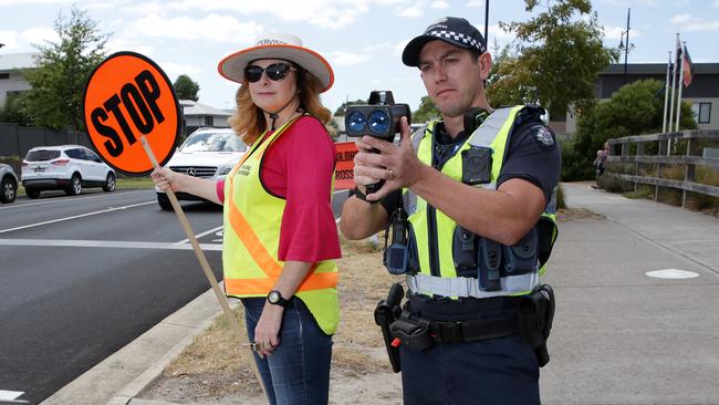 Drivers are disobeying the school speed limit on Mernda Village Drive. Lollipop lady Kirsty Meulblok and Senior Constable Adam Glogolia try and control the traffic. Picture: George Salpigtidis