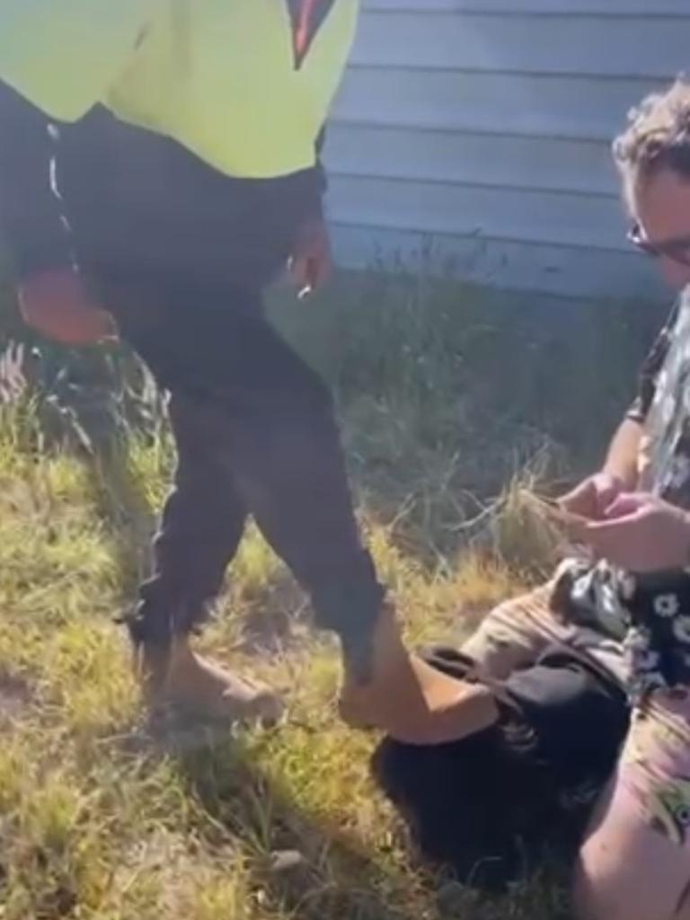 Graeme Kirk places his boot on the boy’s head during the citizens arrests while Jeff McLaughlin sits on the child.