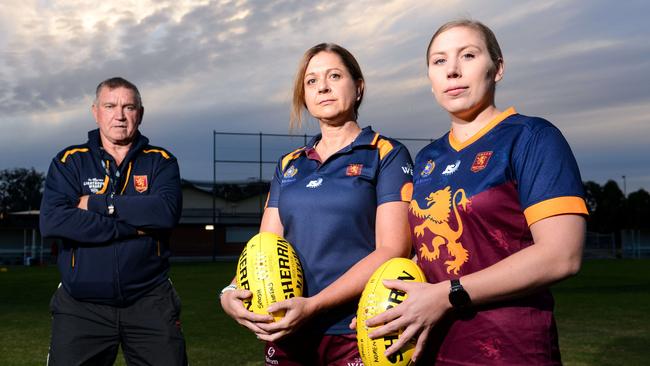 SMOSH West Lakes coach Greg Phillips with women’s stars Nicky Noble and Georgie Evans. The two players may miss out on watching the AFLW grand final with the matches set to clash. Picture: Brenton Edwards