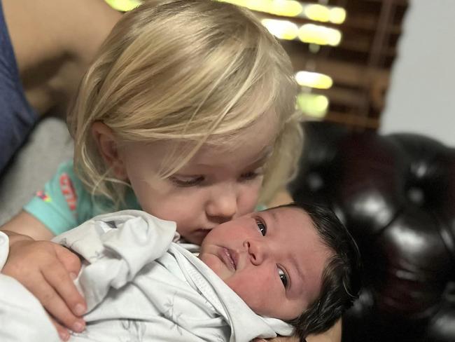 Mia Riley, 5 weeks old, couldn’t be saved after two rottweilers attacked her while she slept in a bouncer. Pictured with her older sister Layla Picture: Facebook