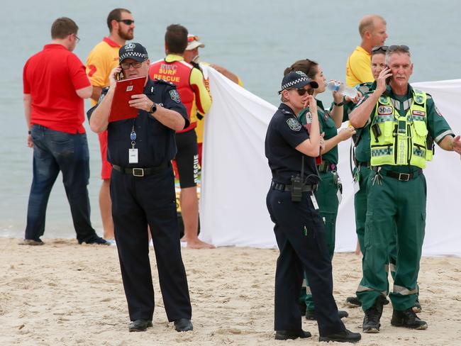 Police and paramedics at Glenelg beach. Picture: AAP / Russell Millard