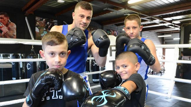 Young boxers Milan 10, Armando 14, and Zayden 6, with Australian Commonwealth Games boxer Terry Nickolas at Fortus Team Gym. The gym won SA’s best metropolitan club award for a third consecutive year. Picture: AAP/Brenton Edwards