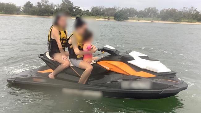 A four-year-old child being carried on a jet ski without a lifejacket on the Gold Coast on Australia Day. Picture: MSQ