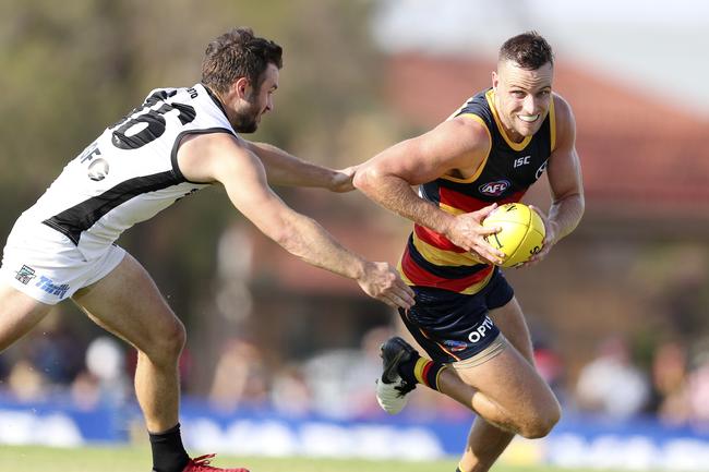 Crows Brodie Smith runs away from Power’s Sam Gray in the JLT game at Port Pirie. Picture SARAH REED